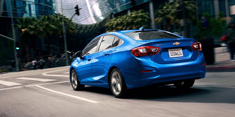 Chevrolet Cruze stopping at a light as it waits to go further into the city