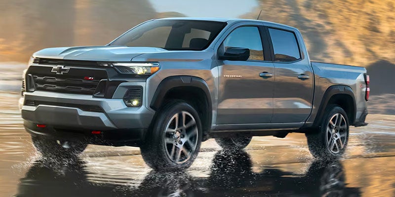 Chevrolet Colorado driving through a puddle of water by the ocean