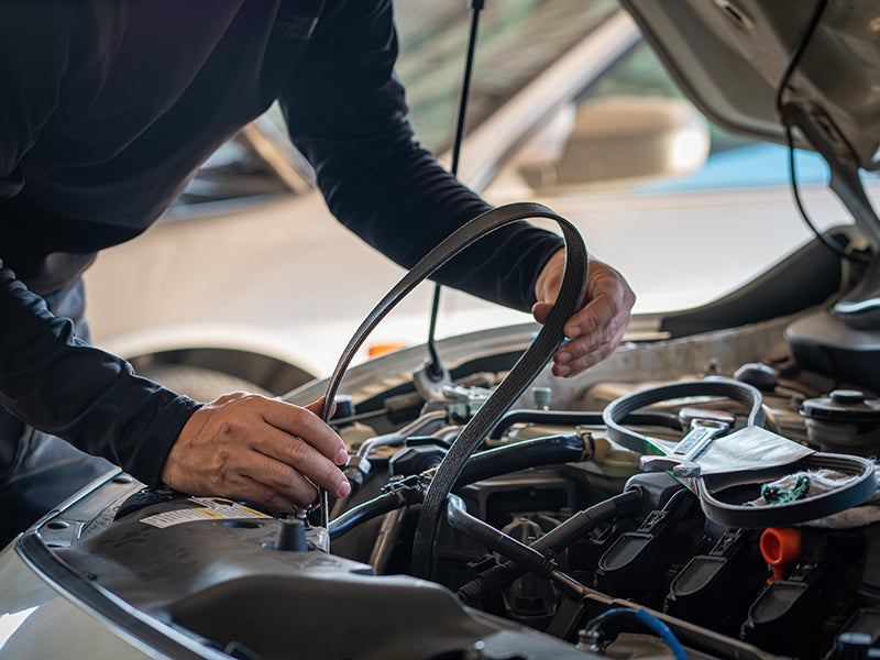 Mechanic changing the car-belt at Criswell Chevrolet of Gaithersburg dealership