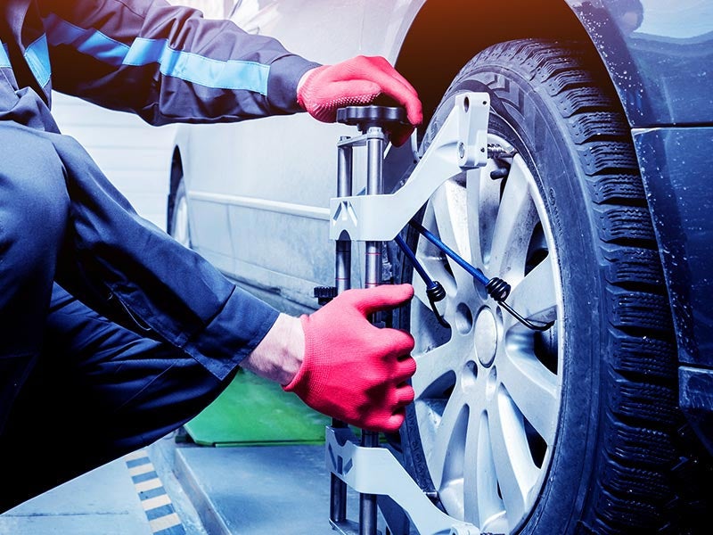 Mechanic performing a wheel alignment at Criswell Chevrolet of Gaithersburg dealership