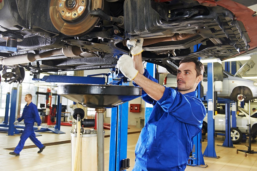mechanic changing oil at the Criswell Chevrolet of Gaithersburg dealership